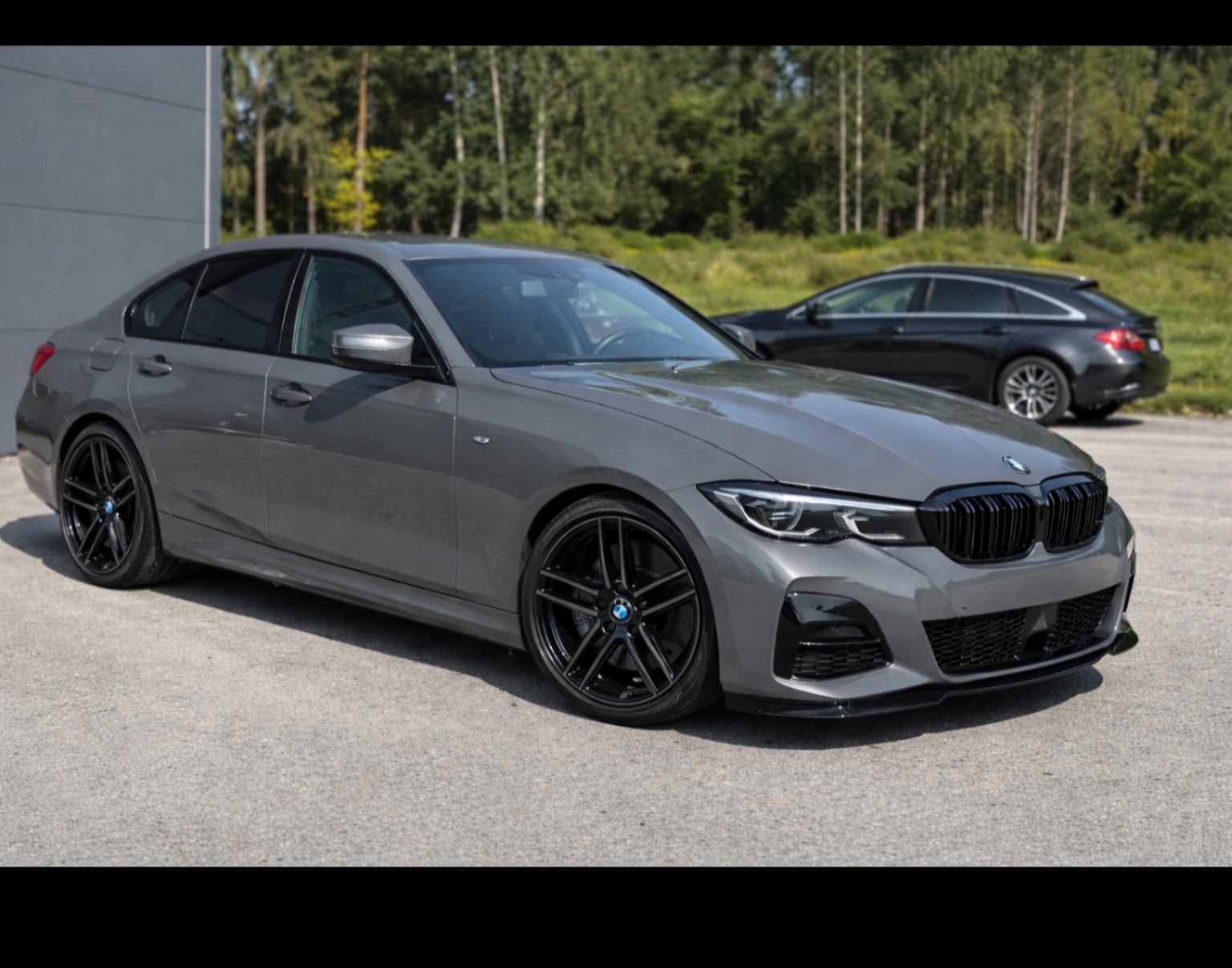 Grey BMW 330e viewed from the front and side
